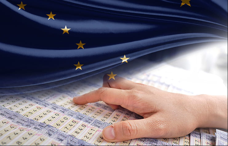 Sets of lottery sheets, with Alaska's flag superimposed over them